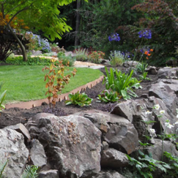Rainbow Gardening & Landscaping - a stone wall in a garden - Gardeners Near Me Rainbow Gardening & Landscaping - a stone wall in a garden - Gardeners Near Me