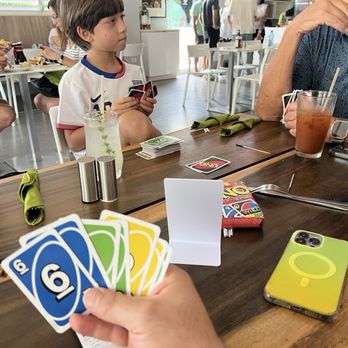 Lluvia Deli Bar - Enjoying a game of UNO. - Coffee & Tea Near Me - Rio Grande, Puerto Rico Lluvia Deli Bar - Enjoying a game of UNO. - Coffee & Tea Near Me - Rio Grande, Puerto Rico