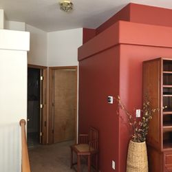 Pat's Painting and Restoration - Main floor hall with accent wall. Refinished stairway spindles.
