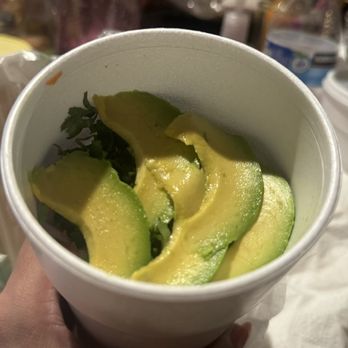 Mariscos Puerto Angel - a person holding a cup of avocado - Mexican Near Me - VanNuys, California