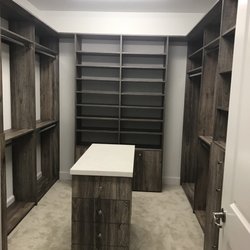 Doctor Closet The Original Corp. - Master closet with island and stone tops.