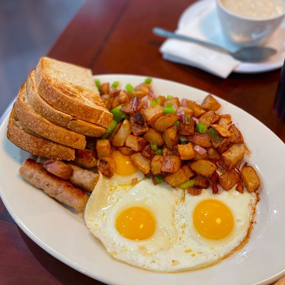 Full breakfast with sausage, country potatoes and a side of country gravy