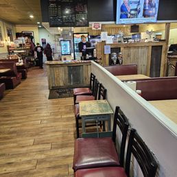 The interior of the restaurant, with waiting benches up front and the ordering counter towards the back. The interior of the restaurant, with waiting benches up front and the ordering counter towards the back.