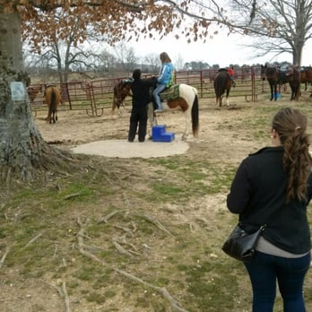 Natchez Trace Stables - Instructors helping everyone get saddled - Horseback Riding Near Me - Primm Springs, Tennessee Natchez Trace Stables - Instructors helping everyone get saddled - Horseback Riding Near Me - Primm Springs, Tennessee