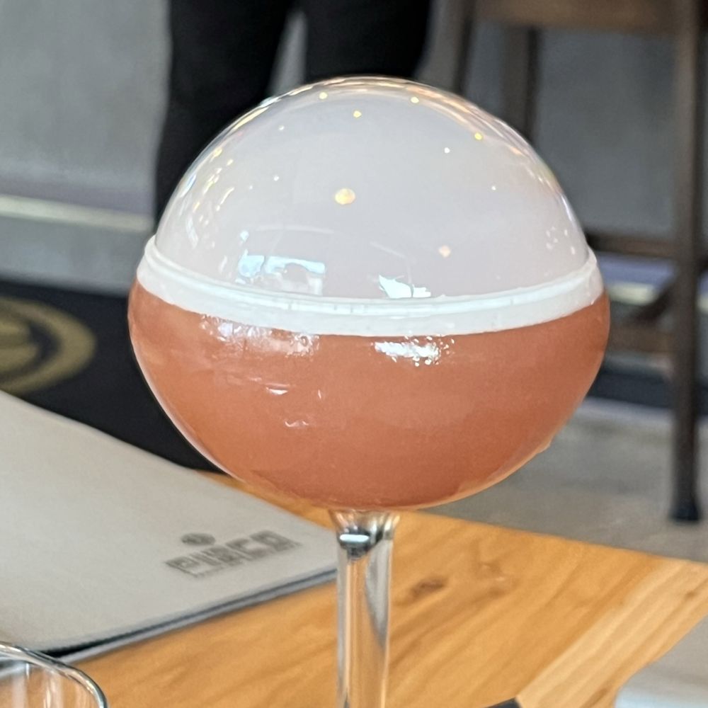Pisco Peruvian Gastrobar - Their signature drink, before bursting it. - Peruvian Near Me - Orlando, Florida