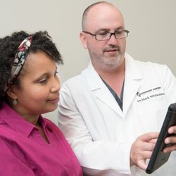 Southwest Austin Foot & Ankle Clinic - Dr. Whitesides sharing an x-ray with a patient on the iPad