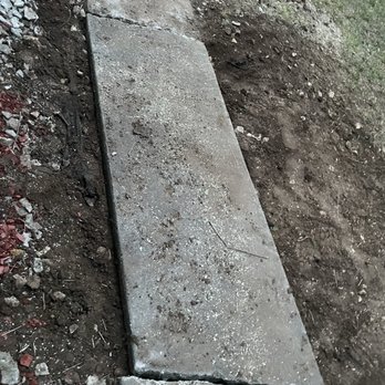 Wilson Landscape Maintenance Services - Wilson removed remaining tree trunk and large roots that had grown under the cement and were heading towards the house. - Landscaping Near Me