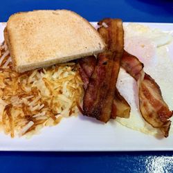 Rise and Dine - Breakfast with over medium eggs, bacon, hash browns and rye toast.