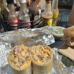 Breakfast burrito with bacon, hash browns, and cheese.