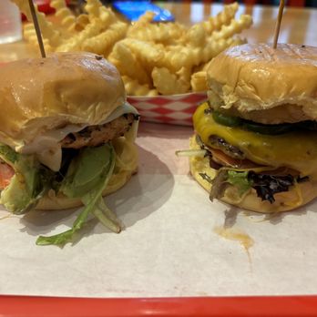 iniBurger - Gourmet Burgers - Malibu Bae Grilled Chicken Sandwich (mini) and Hawaiian Spice Burger (mini) with Fries in the background - Burgers Near Me - Pleasanton, California iniBurger - Gourmet Burgers - Malibu Bae Grilled Chicken Sandwich (mini) and Hawaiian Spice Burger (mini) with Fries in the background - Burgers Near Me - Pleasanton, California
