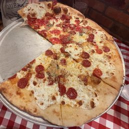 Quattro Formaggi Pizza with added Pepperoni and half red sauce Quattro Formaggi Pizza with added Pepperoni and half red sauce