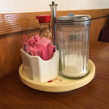 Ocean Pearl - a table with a jar of salt and a container of pink napkins - Chinese Near Me - Delta, Colorado Ocean Pearl - a table with a jar of salt and a container of pink napkins - Chinese Near Me - Delta, Colorado