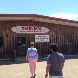 two people walking in front of a restaurant two people walking in front of a restaurant