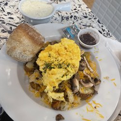 Thumbs Up Diner - The Skillet Heap with scrambled eggs, biscuit, and a side of grits.