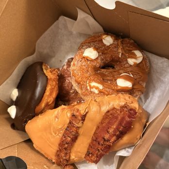 Voodoo Doughnut - Bacon Maple Bar, Portland Cream, Churro Cheesecake, Apple Fritter - Donuts Near Me - Miami, Florida Voodoo Doughnut - Bacon Maple Bar, Portland Cream, Churro Cheesecake, Apple Fritter - Donuts Near Me - Miami, Florida
