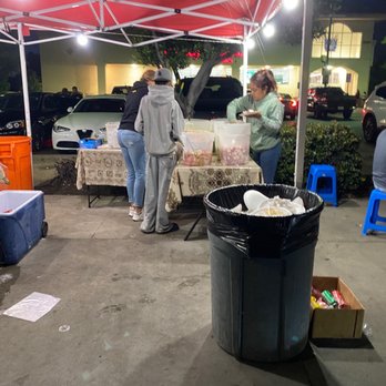 Morales Tacos - a group of people standing under a tent - Tacos Near Me - Los Angeles, California