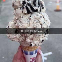 Small sugar cone with peanut butter Oreo ice cream.