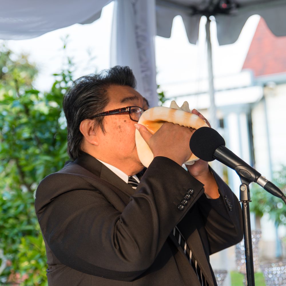 Mobile Reverend A. Mauricio Lubong - Man of many talents! A special Hawaiian inspired conch blowing ritual for the start of our ceremony. Photo Credit: Tommy Pham - Officiants Near Me Mobile Reverend A. Mauricio Lubong - Man of many talents! A special Hawaiian inspired conch blowing ritual for the start of our ceremony. Photo Credit: Tommy Pham - Officiants Near Me