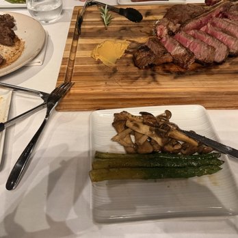 The Steak Library - Aged tomahawk, t-bone ribeye both medium rare with asparagus and mushrooms. - Steakhouses Near Me - Lomita, California The Steak Library - Aged tomahawk, t-bone ribeye both medium rare with asparagus and mushrooms. - Steakhouses Near Me - Lomita, California