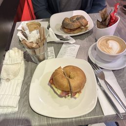 Breakfast bagel on an everything bagel and a bacon egg and cheese bagel on a plain bagel