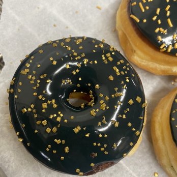 Top Donuts - Vanilla frosting in black with gold sprinkles - Donuts Near Me - Norwalk, California Top Donuts - Vanilla frosting in black with gold sprinkles - Donuts Near Me - Norwalk, California