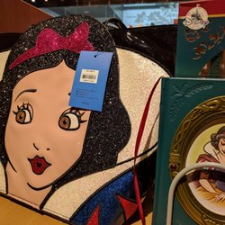 Disney Store - With the 80th anniversary of "Snow White and the Seven Dwarfs" being celebrated this year, you'll items like this luxe handbag & journal.