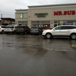 cars parked in front of a starbucks coffee shop cars parked in front of a starbucks coffee shop
