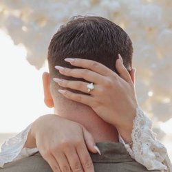Oval diamond engagement ring flanked by two pear-shaped diamonds