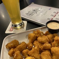 Grand Slam Restaurant and Bar - Breaded Cauliflower app with a tall Mango Cart on draft