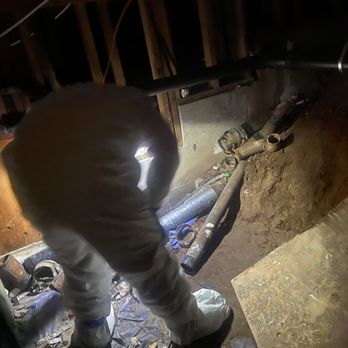 BH Environmental - Technician cleans up debris in flooded area under the condo. - Damage Restoration Near Me BH Environmental - Technician cleans up debris in flooded area under the condo. - Damage Restoration Near Me