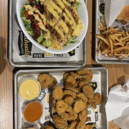 House salad with grilled chicken, fried pickles and sliders House salad with grilled chicken, fried pickles and sliders