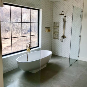 Camdon Construction - a bathtub in a bathroom with a large window - General Contractors Near Me - St Charles, Missouri