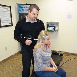 Forever Young Chiropractic - Dr. Jay is adjusting a patient mechanically by using the Arthrostim instrument.