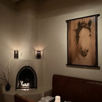 Geronimo - a dining room with a fireplace - French Near Me - Santa Fe, New Mexico
