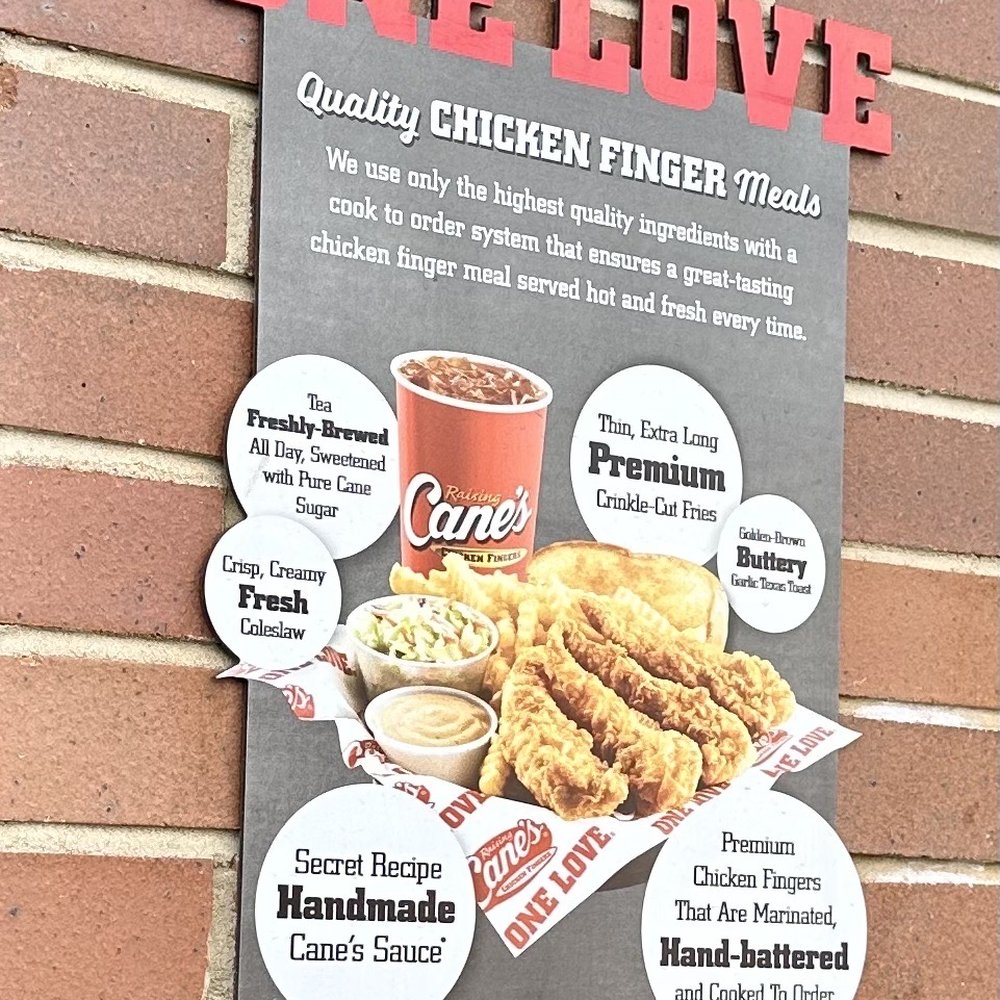 Raising Cane's Chicken Fingers - a menu on a brick wall - Chicken Shop Near Me - Chester, Virginia