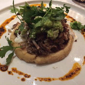 Xochi - Memela - toasted masa pancake, roasted pork rib, refritos, crema, queso fresco, salsa de albanil - Mexican Near Me - Houston, Texas
