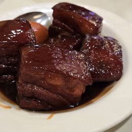 Red braised pork belly, one of the three premier specials Red braised pork belly, one of the three premier specials