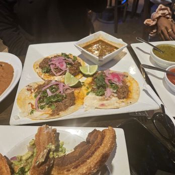 Fronteras - All of it. Birria tacos, red and green salsas, pork belly guac, side of refried beans. - Mexican Near Me - Columbus, Ohio