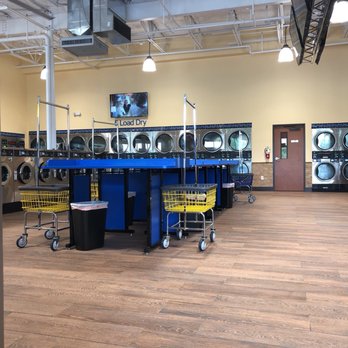 SpinZone Laundry - Folding areas with 5-old dryers in the background - Laundromat Near Me - Round Rock, Texas