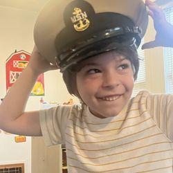 Seeds of Tomorrow Preschool - Veterans Day pride! Little learner wears his father's Marine hat as his father Chief Officer shares what it means to be a veteran.