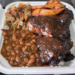 Chef Irie's Jamaican Kitchen - Jerk leg quarter meal, chicken topped with Chef's jerk sauce, along with 2 sides: smoked baked beans, stew cabbage, and fried plantain