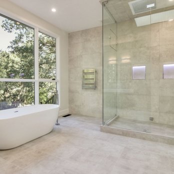 Seyed Construction - a modern bathroom with a large window - General Contractors Near Me