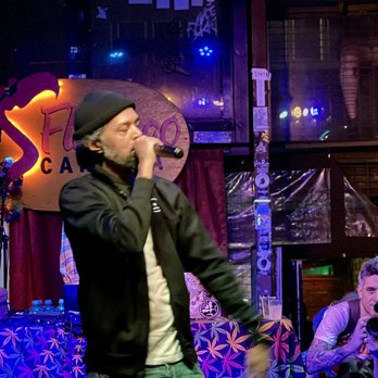 Flamingo Cantina - a man on stage singing into a microphone - Bars Near Me - Austin, Texas