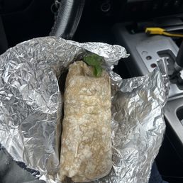 A chicken burrito without pico de gallo.