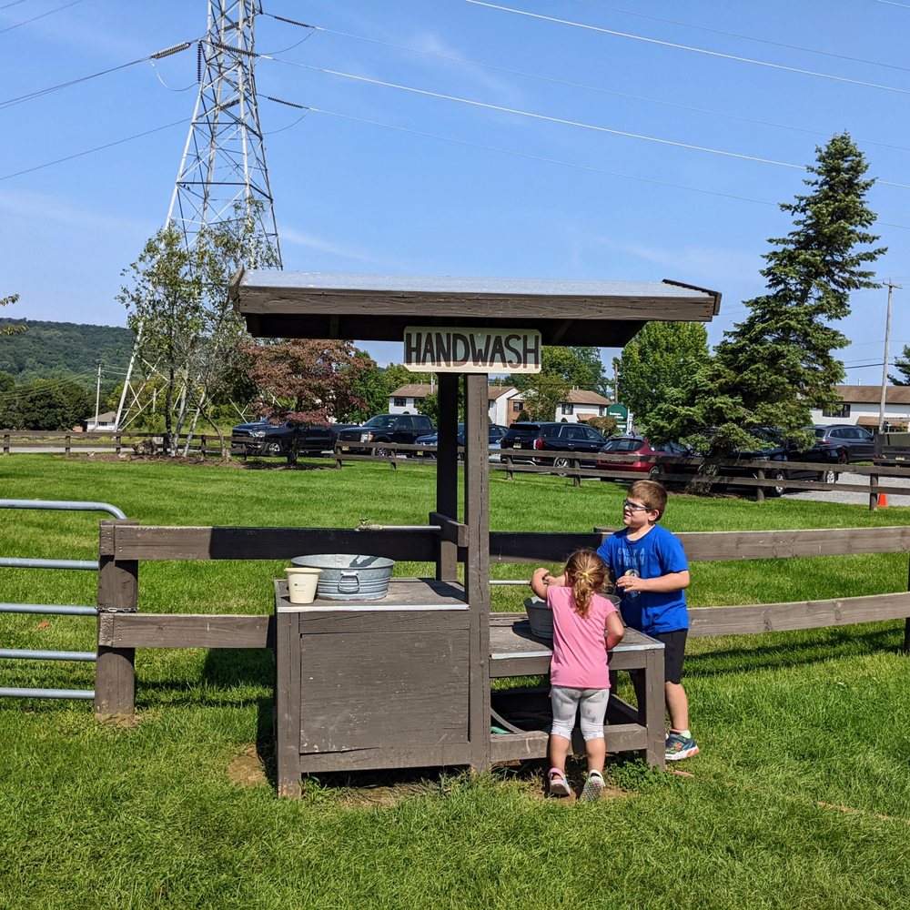 Donaldson Farms - a man and a little girl standing in front of a well - Fruits & Veggies Near Me - Hackettstown, New Jersey
