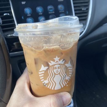 Starbucks - a hand holding a cup of iced coffee - Coffee & Tea Near Me - Petoskey, Michigan