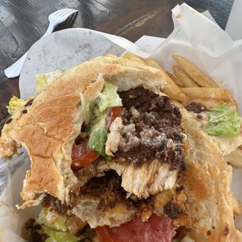 Bluma's Chicken & Waffles - Fried chicken sandwich showing bun breaking a part - Food Trucks Near Me