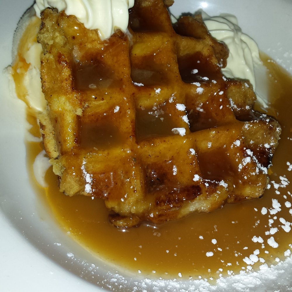 Waffles with butterscotch and maple syrup, ice cream and cream Waffles with butterscotch and maple syrup, ice cream and cream