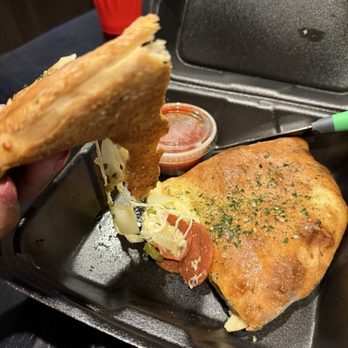 Ilario's Italian Cuisine - Calzone* with pepperoni, onion, and bell pepper - Italian Near Me - Kyle, Texas Ilario's Italian Cuisine - Calzone* with pepperoni, onion, and bell pepper - Italian Near Me - Kyle, Texas