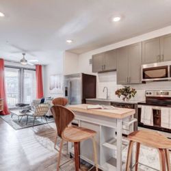 The Preserve at Preston Trail - a kitchen and living room with a table and chairs at The Preserve at Preston Trail